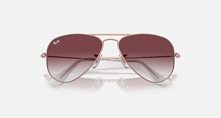 Metal aviator sunglasses with rose-gold frame and dark maroon gradient lenses, close front view