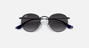Ray-Ban round sunglasses with black frame top and dark lenses, blue temple arms