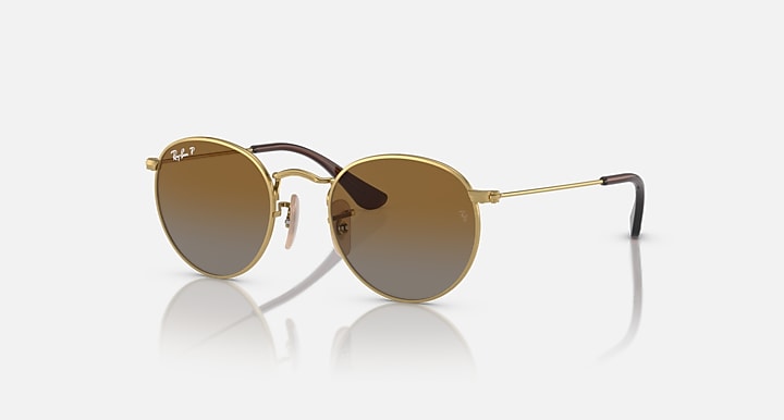 Round Ray-Ban sunglasses with gold frame and warm brown lenses