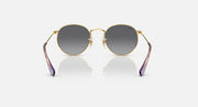 Round Ray-Ban sunglasses with gold frame, dark gray lenses, and purple temple detail