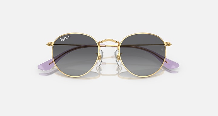 Round Ray-Ban sunglasses with gold frame and brown gradient lenses