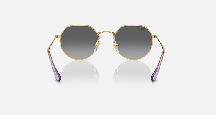 Ray-Ban Junior Jack kids round sunglasses, gold frame, dark gray lenses, purple temple tips, front view.