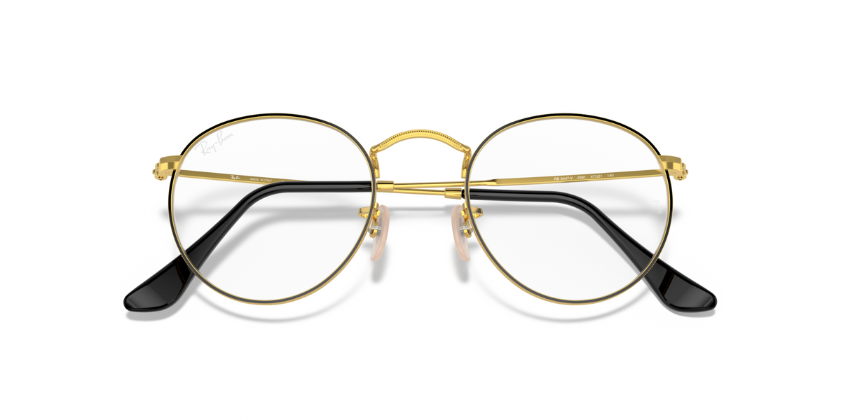 Round metal prescription eyeglass frames, gold and black with dark lenses
