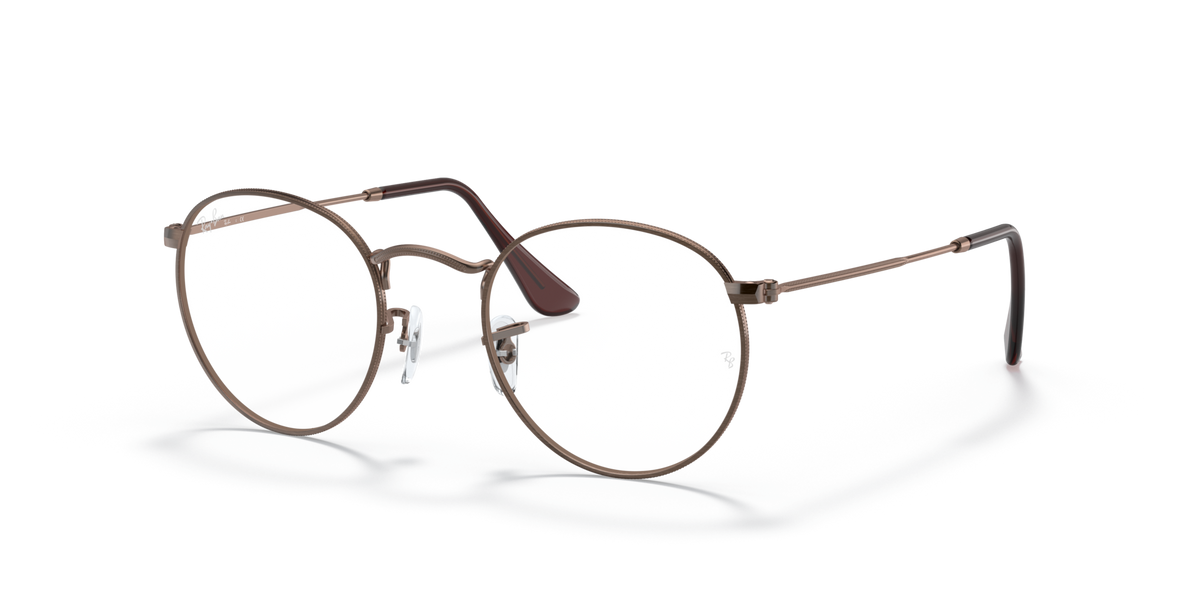 Round metal prescription eyeglass frames with warm brown rims and dark lenses