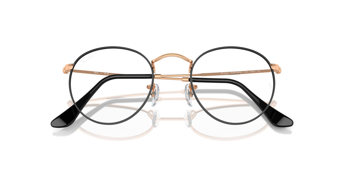 Front view of round metal prescription eyeglass frames with dark lenses and rose-gold frame