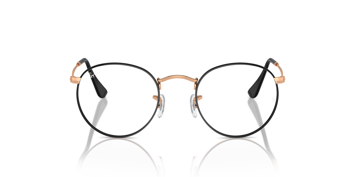 Round metal prescription eyeglass frames with dark rims and rose-gold bridge