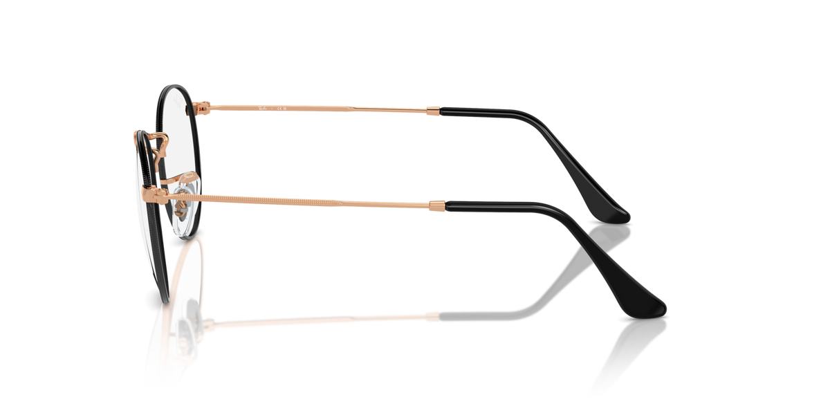 Side view of round metal prescription eyeglass frames with dark rims and gold temples