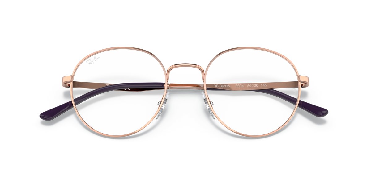 Ray-Ban prescription frames with rose-gold metal rims and clear lenses, close-up