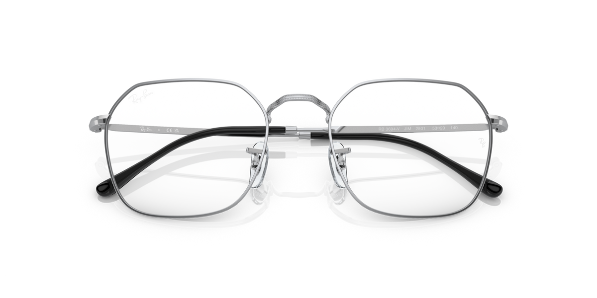 Oval prescription eyewear frames with clear lenses, silver metal, dark accents