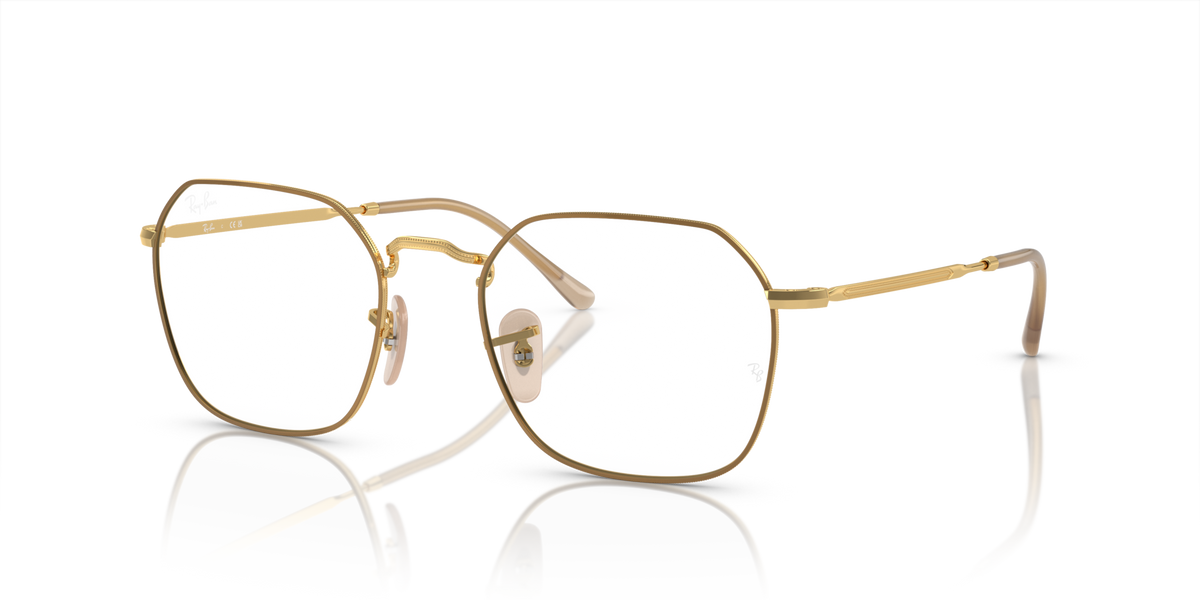 Gold oval prescription eyewear frames with clear lenses, side arms and hinge detail