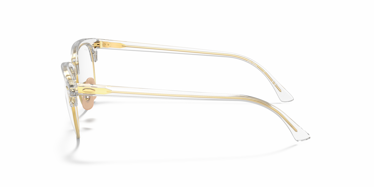 Gold-tone eyeglass frames shown from the side with clear lenses