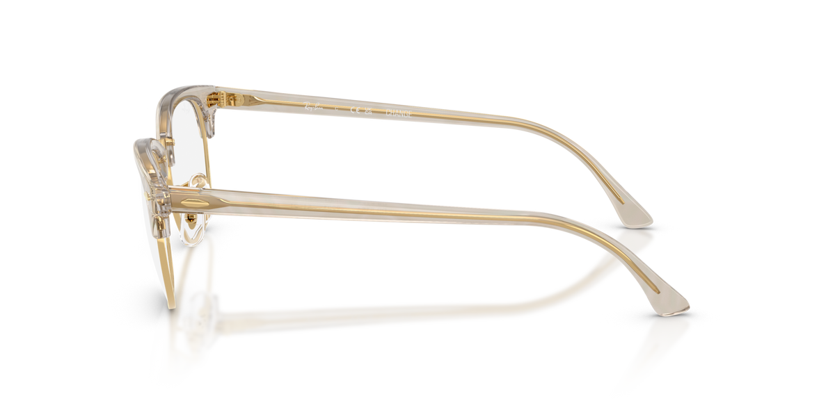 Gold-tone eyeglass frames from the side with clear lenses and hinges