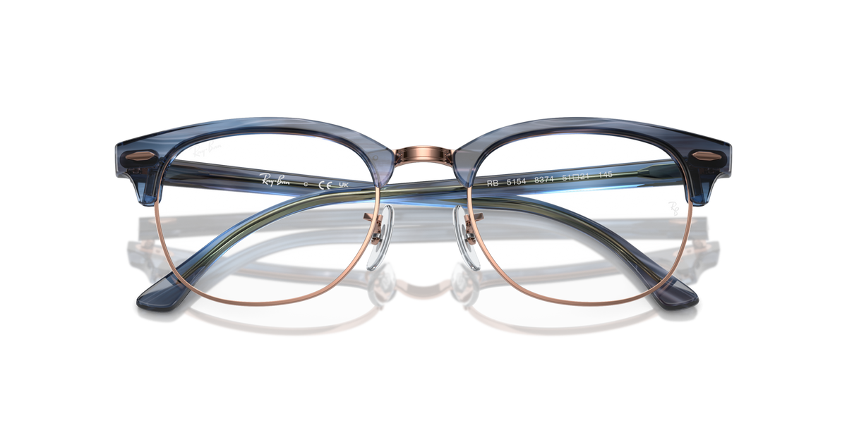 Blue eyeglass frames with gold metal temples and round prescription lenses