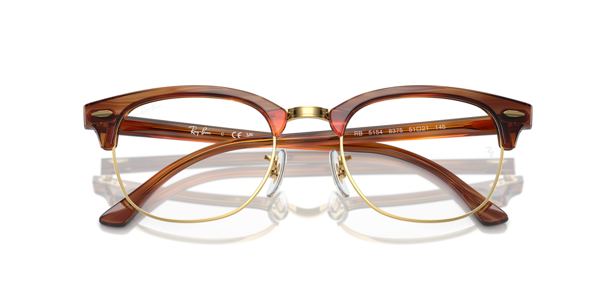 Brown eyeglass frames with gold rims and round prescription lenses