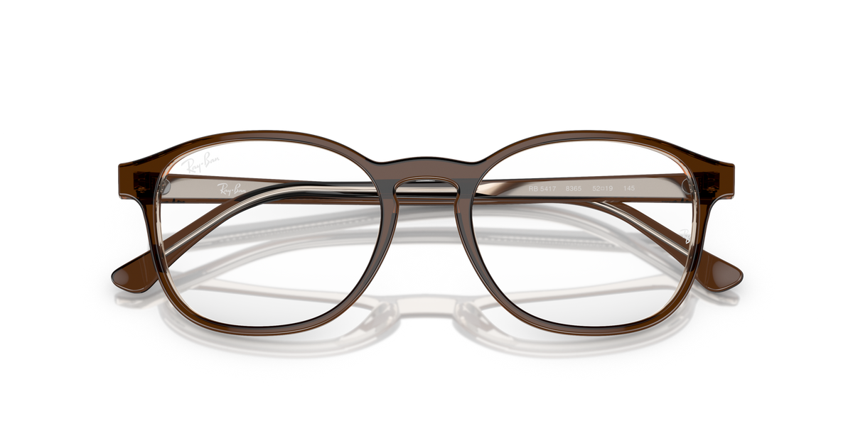 Prescription eyewear frames, brown translucent with white lenses and curved brow