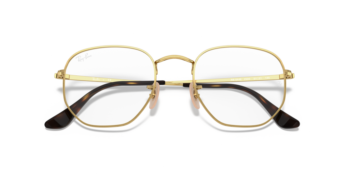 Gold-tone hexagonal prescription eyewear frames with black temple tips, front view