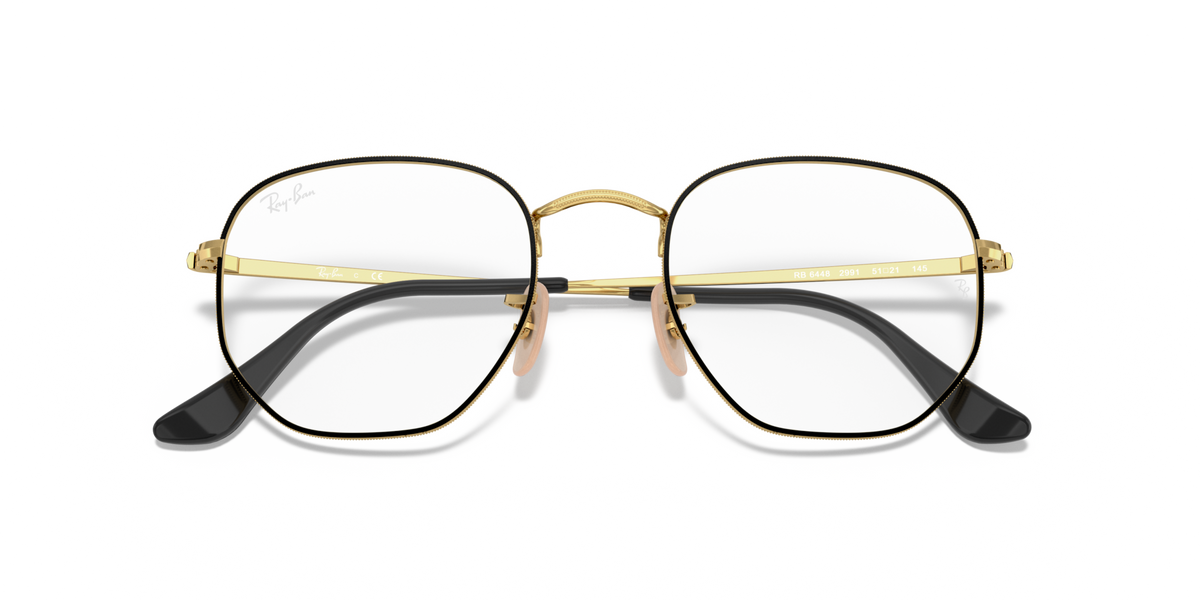 Gold-tone hexagonal prescription eyewear frames with black temple tips, front view