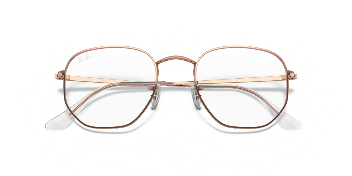 Rose gold hexagonal eyeglass frames with clear lenses and slim bridge