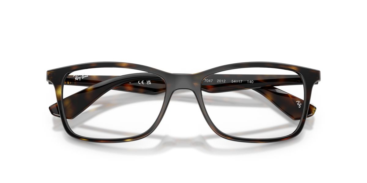 Transparent brown rectangular eyeglass frames with clear lenses and gray temples