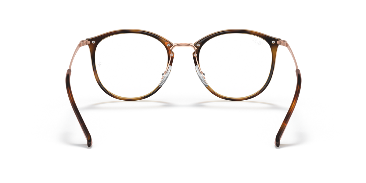 Ray-Ban prescription eyeglass frames, round havana-brown rims with visible clear temple tips
