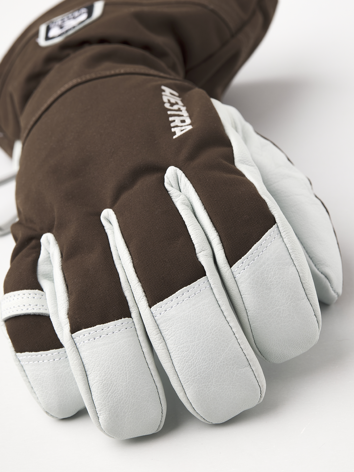Brown ski gloves with light gray palm panels and padded finger sections