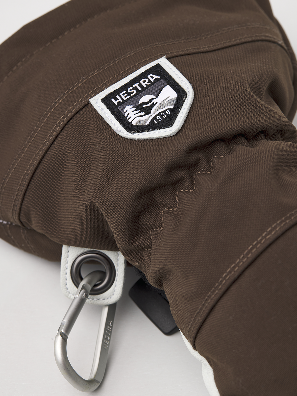 Brown glove cuff with Hestra patch and metal hook carabiner