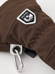 Brown ski mitten with HESTRA logo patch and metal carabiner ring