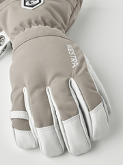 Taupe ski glove with white accents and “Hestra” logo on the back.