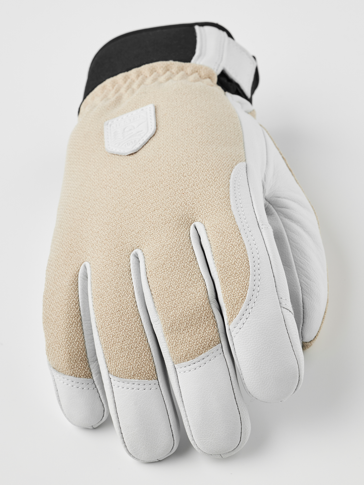 Beige fabric patrol gloves with white leather palm, contrast trim, and stitched finger tips.