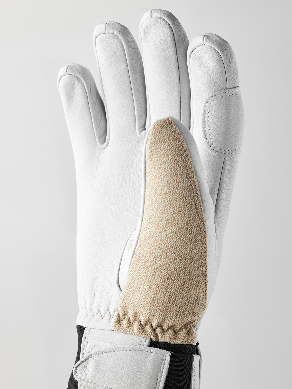 White leather patrol gloves with beige textured palm panel and black cuff trim