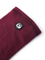 Bordeaux merino wool glove liners with small Hestra logo patch on folded cuff