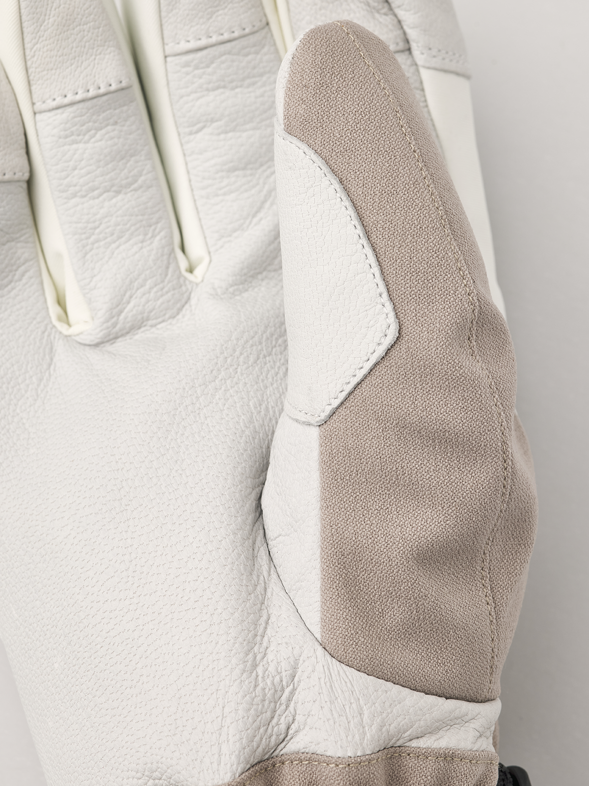 Close-up powder gauntlet gloves: beige fabric with white leather panel and stitching