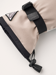 Beige powder gauntlet glove wrist detail with black strap and toggle closure