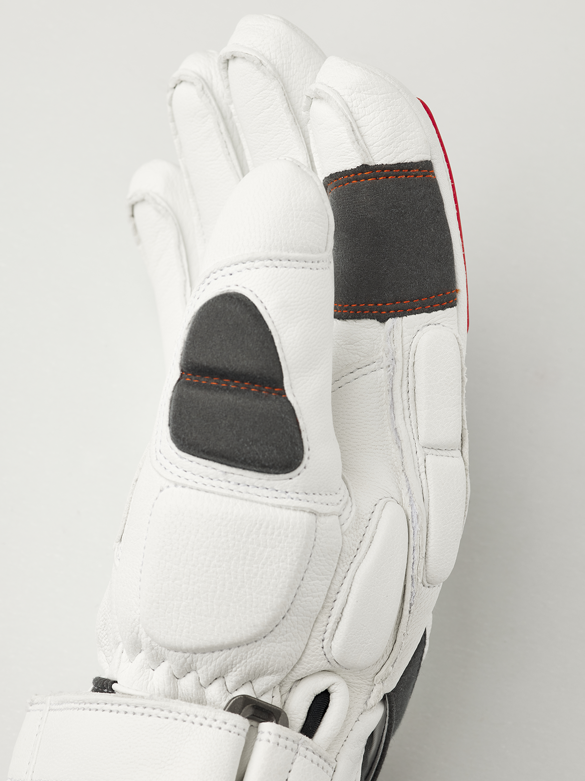 Hestra Impact Racing SR white glove close-up, padded thumb and orange seam details