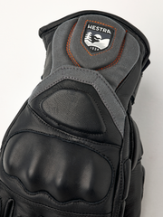 Hestra Impact Racing SR glove top view, black leather with Hestra patch and orange stitching