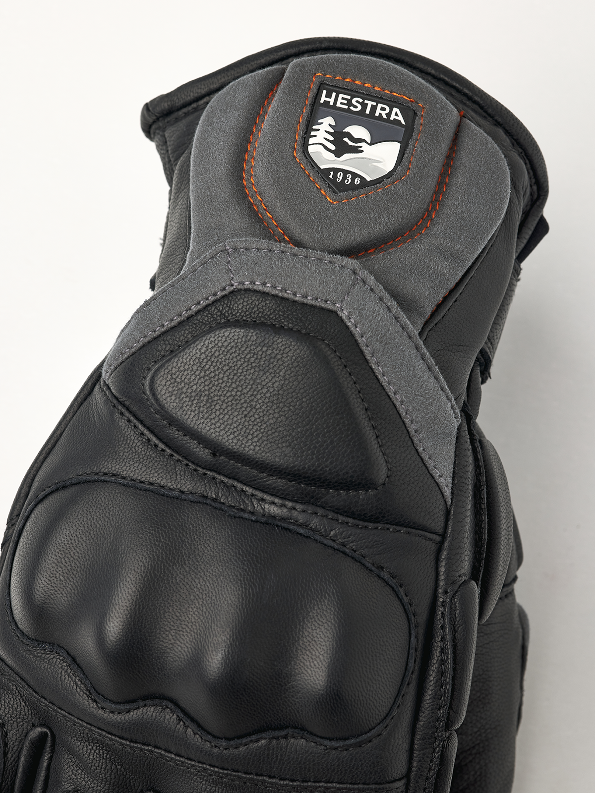 Hestra Impact Racing SR glove top view, black leather with Hestra patch and orange stitching