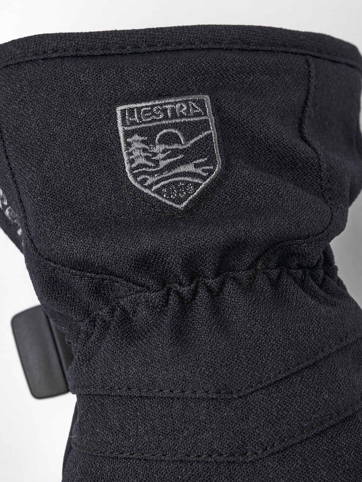 Black junior mitt with Hestra logo patch and gathered wrist cinch