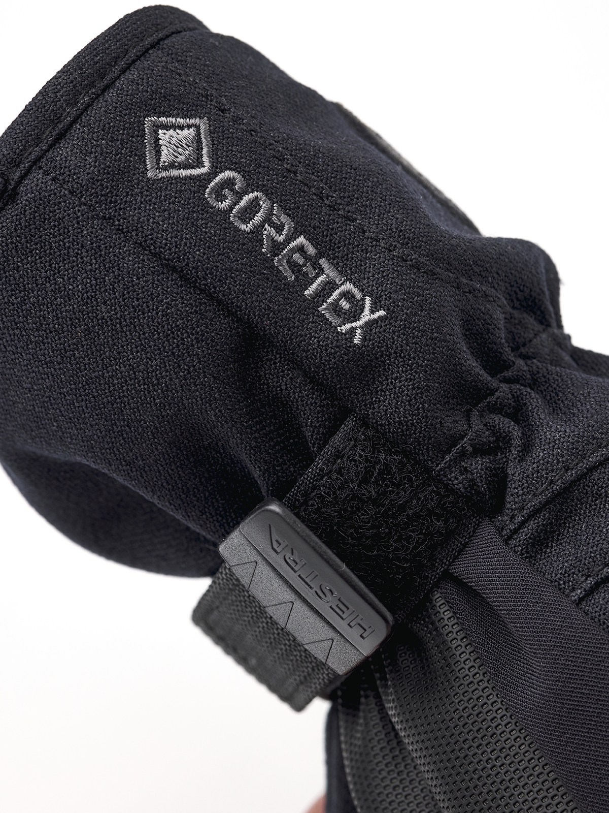 Black junior GORE-TEX mitt with 'GORE-TEX' print and hook-and-loop strap