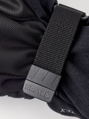 Hestra junior mitt close-up: gray buckle with Hestra logo on strap