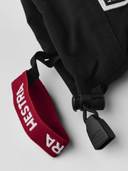 Kids black ski gloves with red fabric wrist strap and quick-release clip