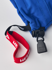 Kids ski gloves detail: blue sleeve with black strap, red logo trim, and white lining