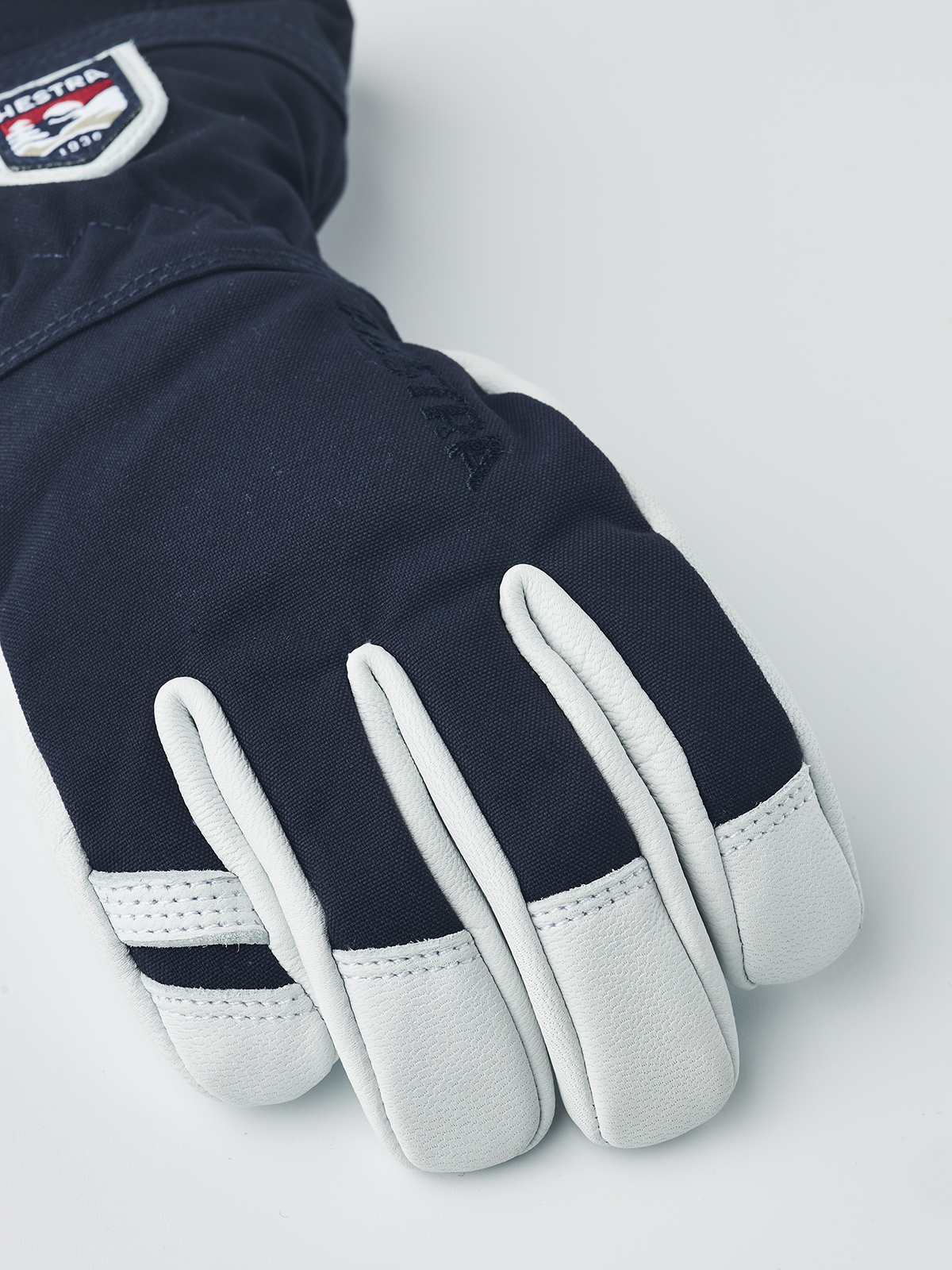 Hestra junior ski gloves in dark navy with white leather palms and wrist strap