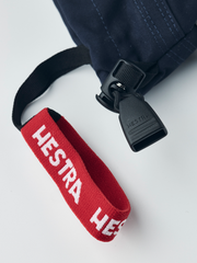 Kids navy ski gloves with red Hestra strap and molded wrist clip