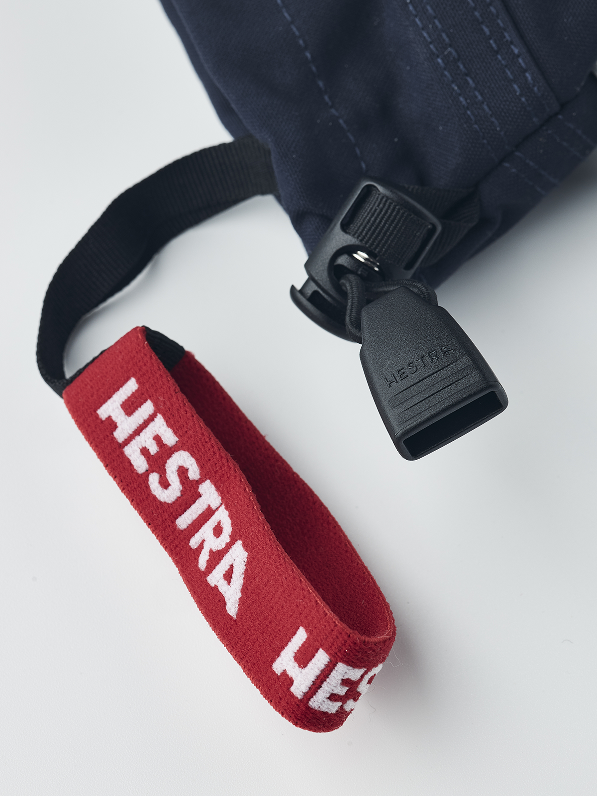Kids navy ski gloves with red Hestra strap and molded wrist clip
