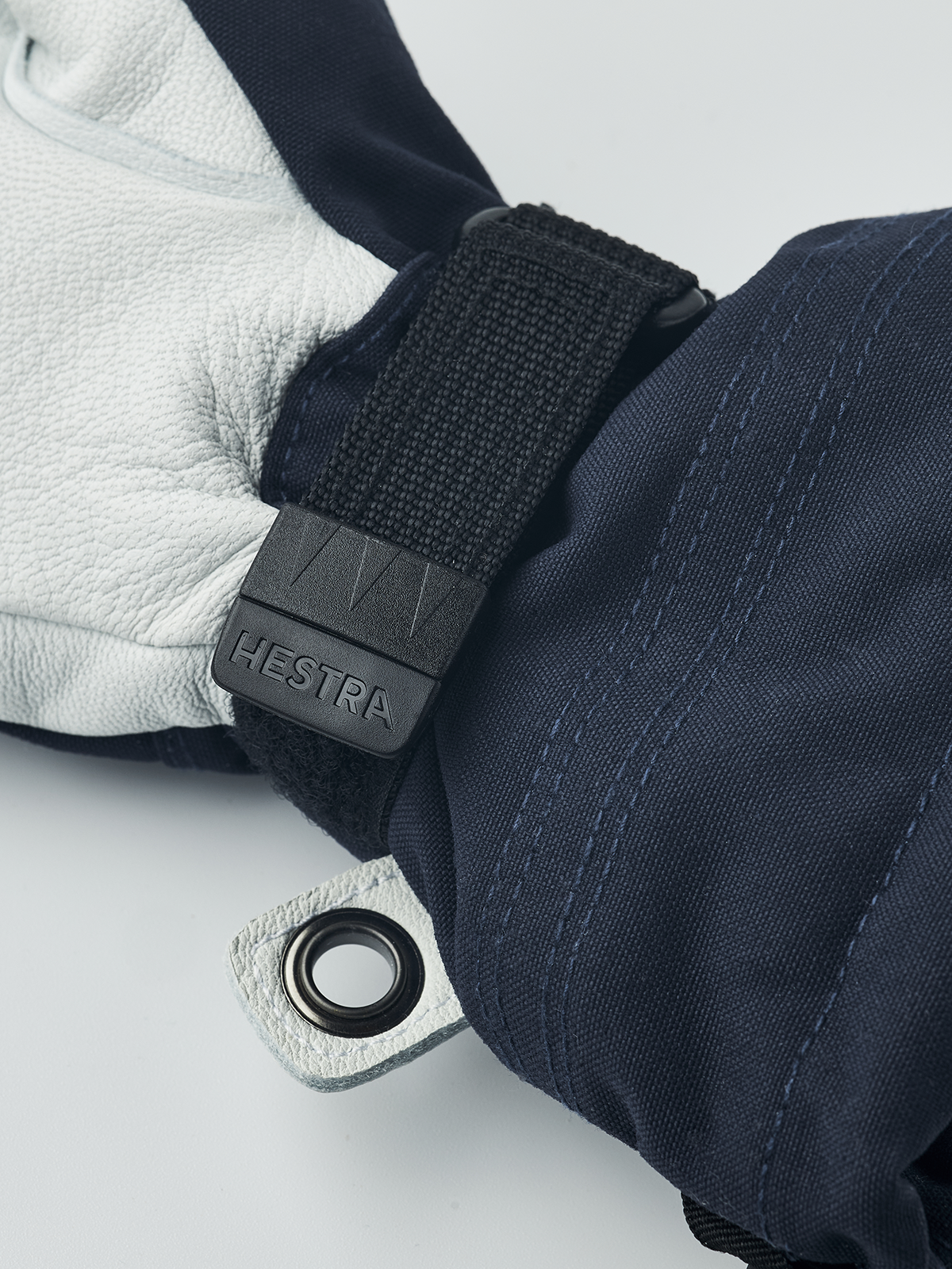 Kids navy ski gloves with dark wrist strap and Hestra logo clip detail