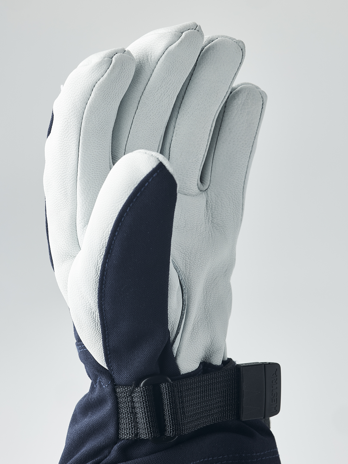 Hestra junior ski gloves in light blue-gray with dark navy palm panel and wrist strap