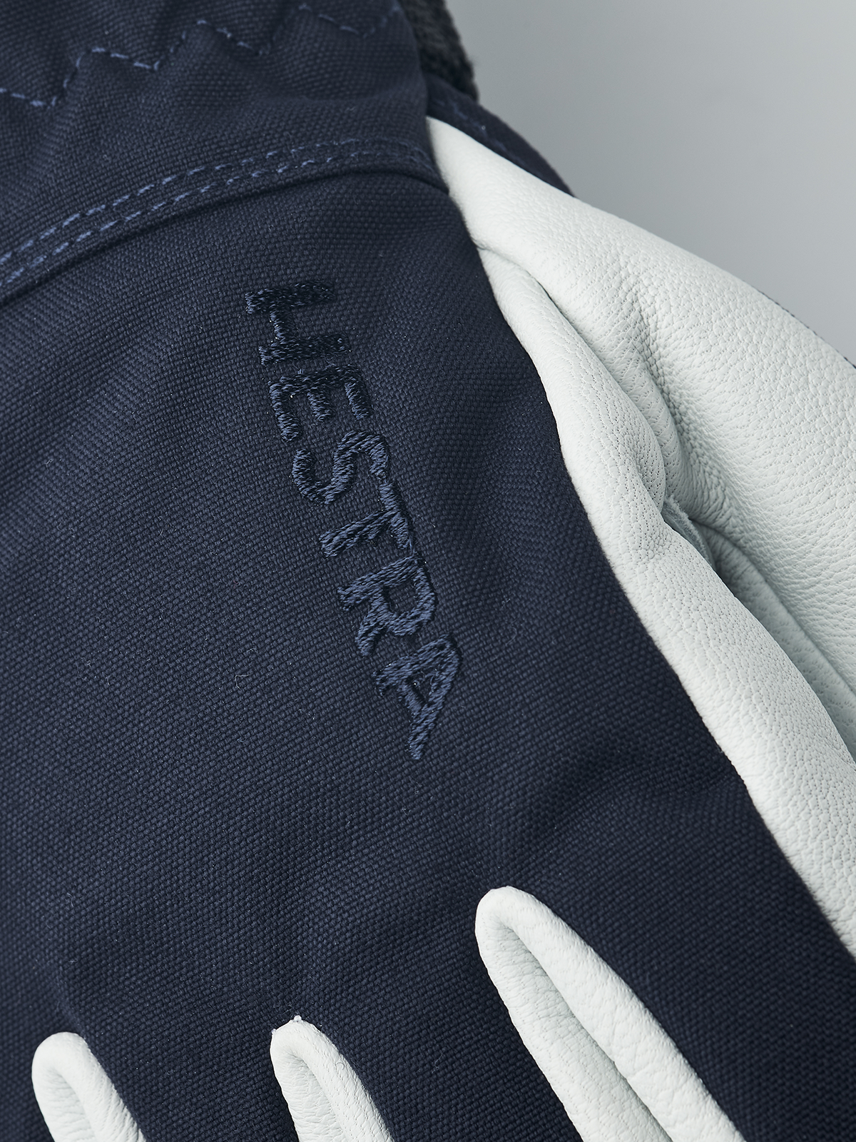 Navy ski junior glove with white leather palm and embroidered HESTRA logo