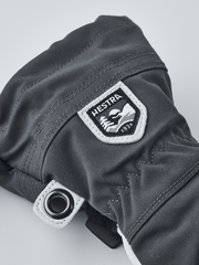 Hestra junior ski gloves in dark gray with Hestra logo patch and metal eyelet