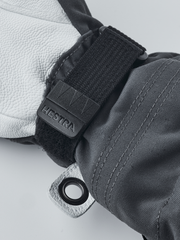 Black ski junior glove wrist strap with Velcro tab and pull-cord grommet