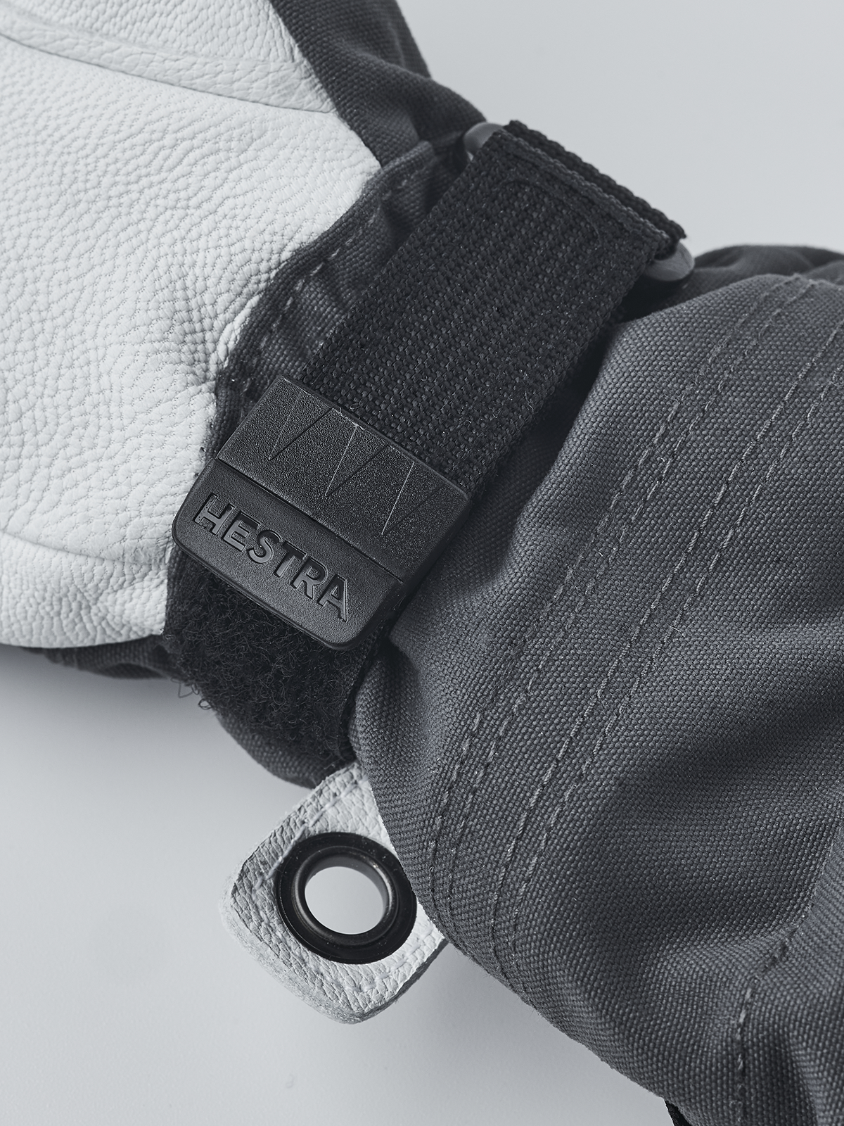 Black ski junior glove wrist strap with Velcro tab and pull-cord grommet